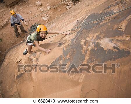 Couple rock climbing View Large Photo Image Stock Image - Couple rock climbing. Fotosearch