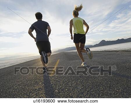 Couple running on road, Utah, United States View Large Photo Image Stock Image - Couple running on road, Utah, United States. Fotosearch