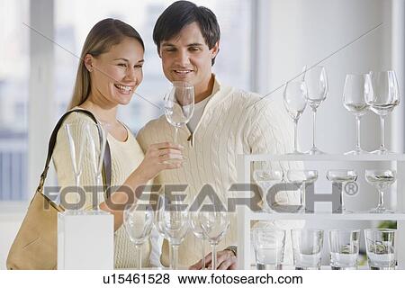 Stock Photo - Couple shopping for glassware. Fotosearch