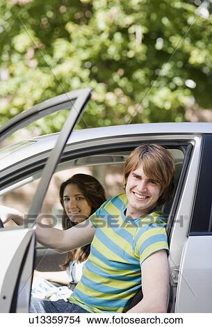 Couple sitting in car View Large Photo Image Picture - Couple sitting in car. Fotosearch