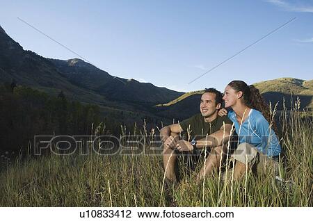 Couple sitting on hillside, Utah, United States View Large Photo Image Stock Image - Couple sitting on hillside, Utah, United States. Fotosearch