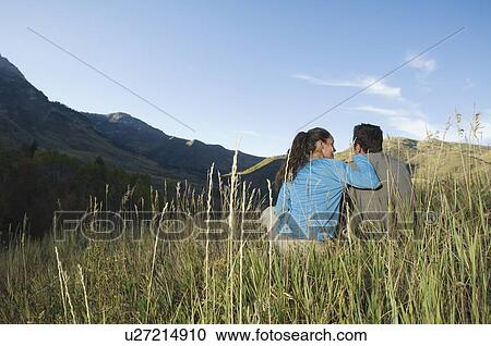 Couple sitting on hillside, Utah, United States View Large Photo Image Stock Image - Couple sitting on hillside, Utah, United States. Fotosearch