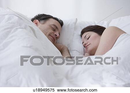 Couple sleeping in bed View Large Photo Image Stock Photography - Couple sleeping in bed. Fotosearch