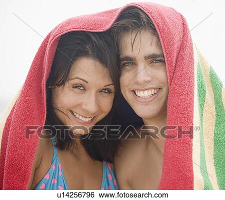 Couple smiling with towel over their heads View Large Photo Image Stock Photograph - Couple smiling with towel over their heads. Fotosearch