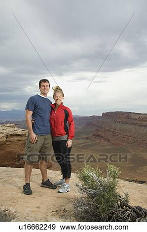 Couple standing at edge of cliff View Large Photo Image Stock Photo - Couple standing at edge of cliff. Fotosearch