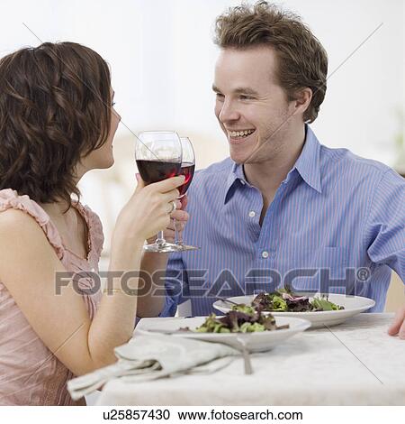 Couple toasting with wine View Large Photo Image Stock Image - Couple toasting with wine. Fotosearch