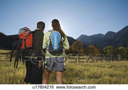 Couple wearing backpacks outdoors, Utah, United States View Large Photo Image Stock Photograph - Couple wearing backpacks outdoors, Utah, United States. Fotosearch