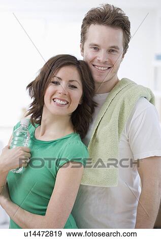 Stock Photo - Couple with towel and water bottle. Fotosearch