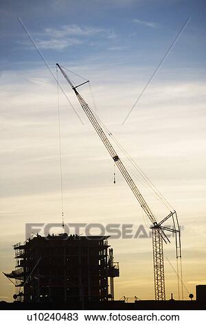 Crane and urban construction site at dusk View Large Photo Image Stock Image - Crane and urban construction site at dusk. Fotosearch