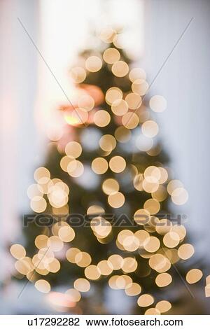 Stock Image - Defocused shot of Christmas tree. Fotosearch