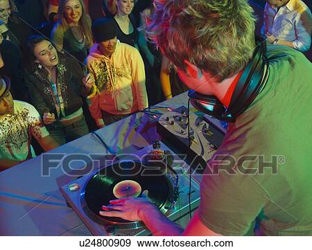 DJ playing in front of crowd View Large Photo Image Stock Photo - DJ playing in front of crowd. Fotosearch