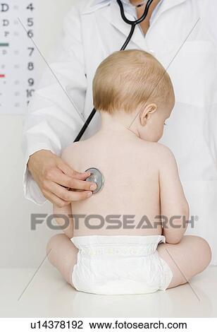 Stock Image - Doctor examining baby. Fotosearch