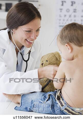 Stock Photo - Doctor examining baby. Fotosearch