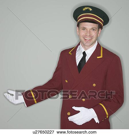 Stock Photo - Doorman making welcoming gesture. Fotosearch