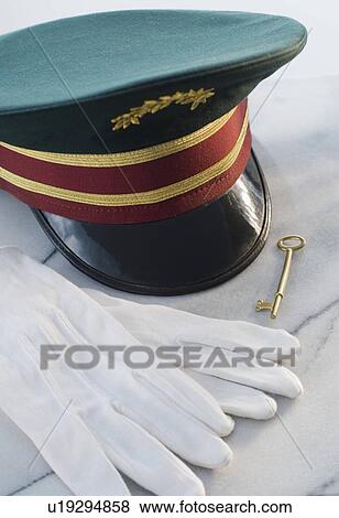 Doorman’s hat, gloves and key on table View Large Photo Image Stock Photo - Doorman’s hat, gloves and key on table. Fotosearch