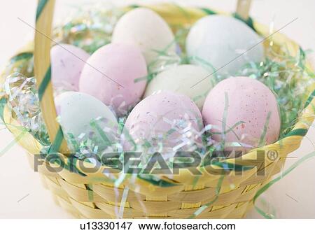 Easter eggs in a basket View Large Photo Image Stock Photo - Easter eggs in a basket. Fotosearch