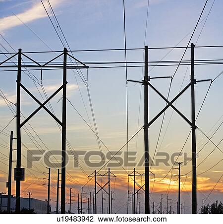 Electrical poles and wires at sunset View Large Photo Image Stock Image - Electrical poles and wires at sunset. Fotosearch