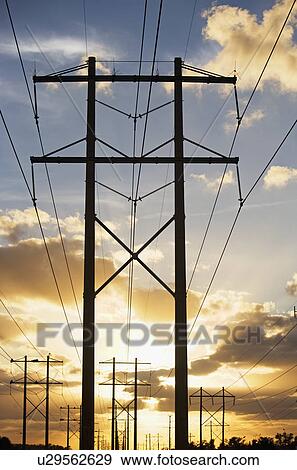 Stock Photo - Electrical poles and wires at sunset. Fotosearch