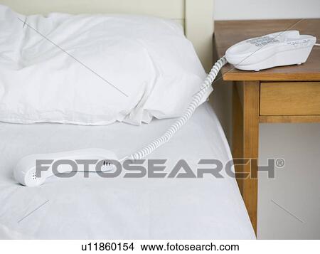 Empty bed with telephone View Large Photo Image Picture - Empty bed with telephone. Fotosearch