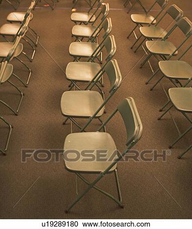Stock Image - Empty folding chairs in rows. Fotosearch