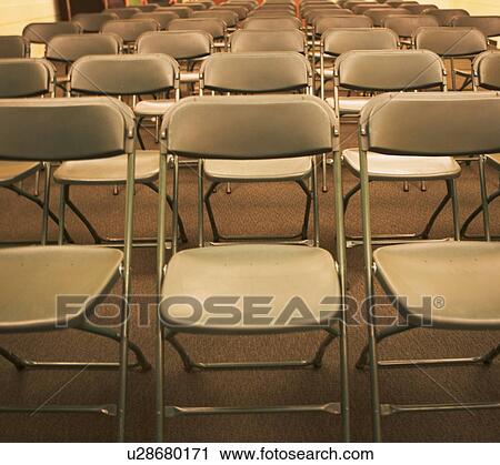 Stock Image - Empty folding chairs in rows. Fotosearch