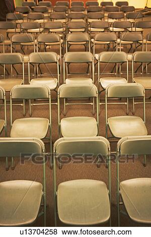 Stock Photo - Empty folding chairs in rows. Fotosearch