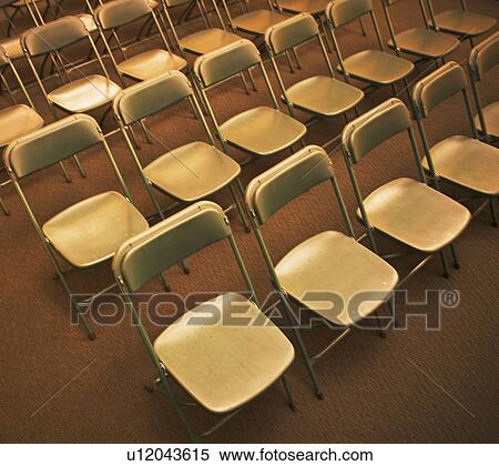 Stock Photography - Empty folding chairs in rows. Fotosearch