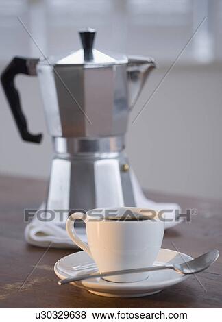 Stock Photo - Espresso in front of coffee pot. Fotosearch