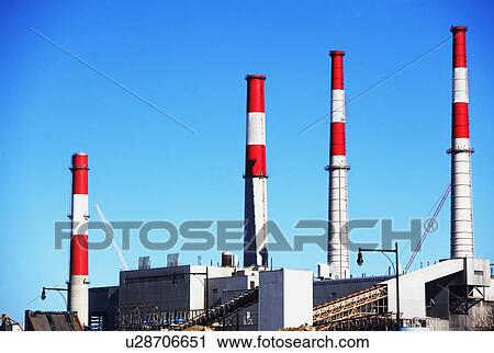 Factory with smoke stacks under blue sky View Large Photo Image Stock Image - Factory with smoke stacks under blue sky. Fotosearch