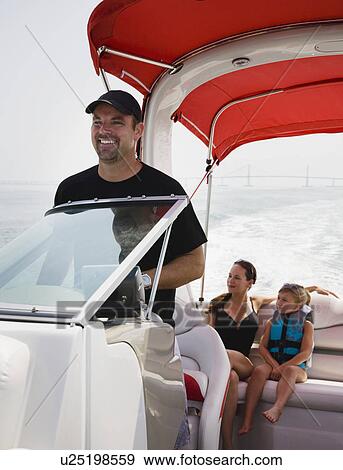 Stock Photo - Family relaxing on boat, Florida, United States. Fotosearch