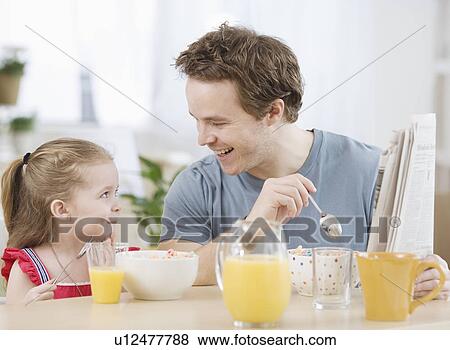 Father and daughter eating breakfast View Large Photo Image Stock Photo - Father and daughter eating breakfast. Fotosearch