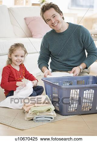 Father and daughter folding laundry View Large Photo Image Stock Photography - Father and daughter folding laundry. Fotosearch