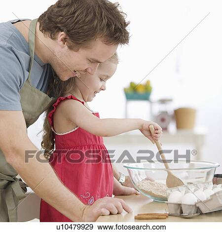 Father and daughter mixing batter in kitchen View Large Photo Image Stock Photo - Father and daughter mixing batter in kitchen. Fotosearch
