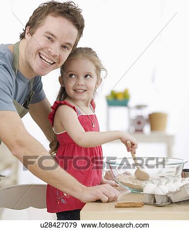 Father and daughter mixing batter in kitchen View Large Photo Image Stock Photo - Father and daughter mixing batter in kitchen. Fotosearch
