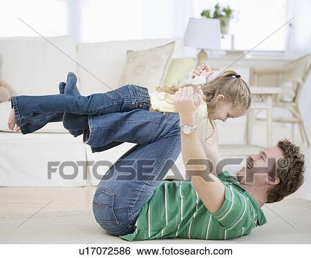 Father and daughter playing on floor View Large Photo Image Stock Photograph - Father and daughter playing on floor. Fotosearch