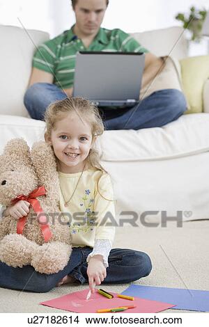 Father and daughter relaxing in livingroom View Large Photo Image Picture - Father and daughter relaxing in livingroom. Fotosearch