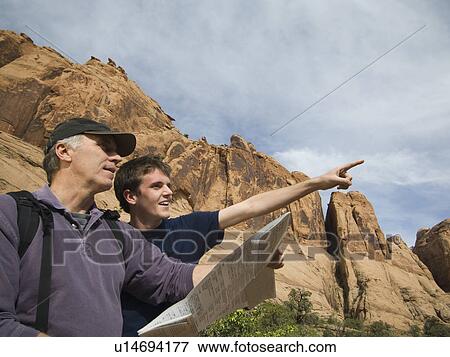 Stock Photo - Father and son using map. Fotosearch