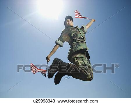 Stock Image - Female army soldier jumping. Fotosearch