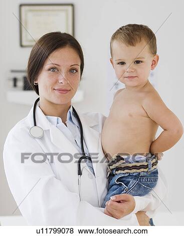 Female doctor holding baby View Large Photo Image Stock Photo - Female doctor holding baby. Fotosearch