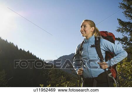Stock Photo - Female hiker looking to side, Utah, United States. Fotosearch