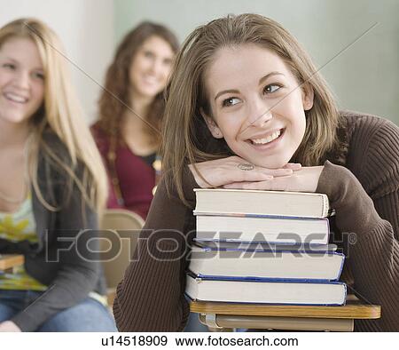 Female student leaning on stack of books View Large Photo Image Stock Photo - Female student leaning on stack of books. Fotosearch