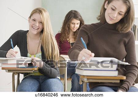 Female students working in classroom View Large Photo Image Stock Photograph - Female students working in classroom. Fotosearch