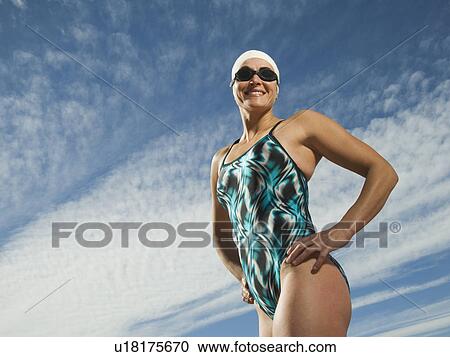 Stock Image - Female swimmer with hands on hips, Utah, United States. Fotosearch