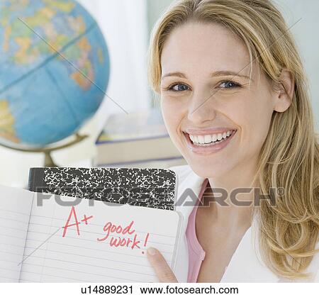 Female teacher holding A plus paper View Large Photo Image Stock Image - Female teacher holding A plus paper. Fotosearch