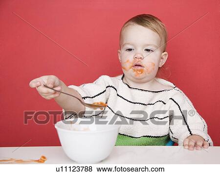 Female toddler eating View Large Photo Image Stock Photo - Female toddler eating. Fotosearch