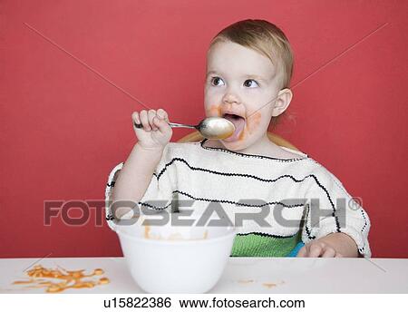 Female toddler eating View Large Photo Image Stock Photograph - Female toddler eating. Fotosearch