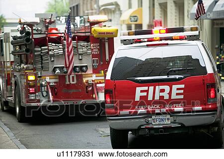 Stock Image - Fire trucks in urban area. Fotosearch
