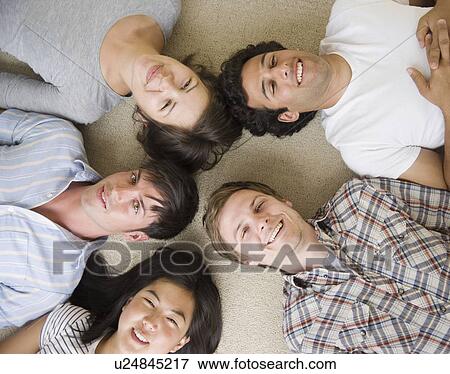 Friends laying on floor View Large Photo Image Stock Photo - Friends laying on floor. Fotosearch