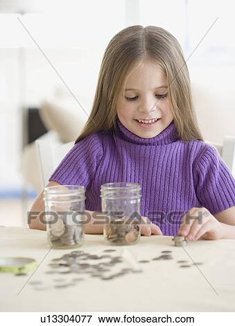 Girl counting and sorting change View Large Photo Image Stock Photo - Girl counting and sorting change. Fotosearch