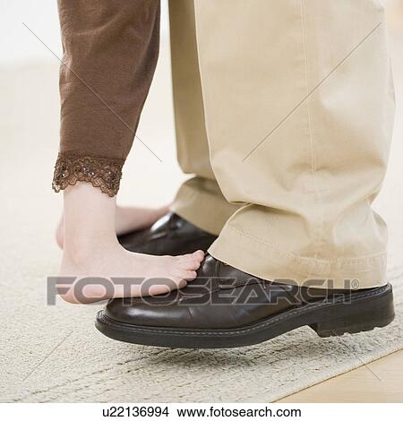 Girl dancing on father’s feet View Large Photo Image Picture - Girl dancing on father’s feet. Fotosearch